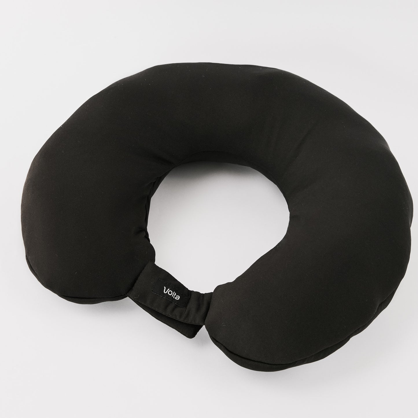 Black travel neck pillow with a compact and ergonomic design, ideal for stuffing with clothes to save luggage space.